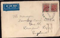 1928 cover from New Zealand to England with UK posyage rates information added to the reverse by postmarking machine.